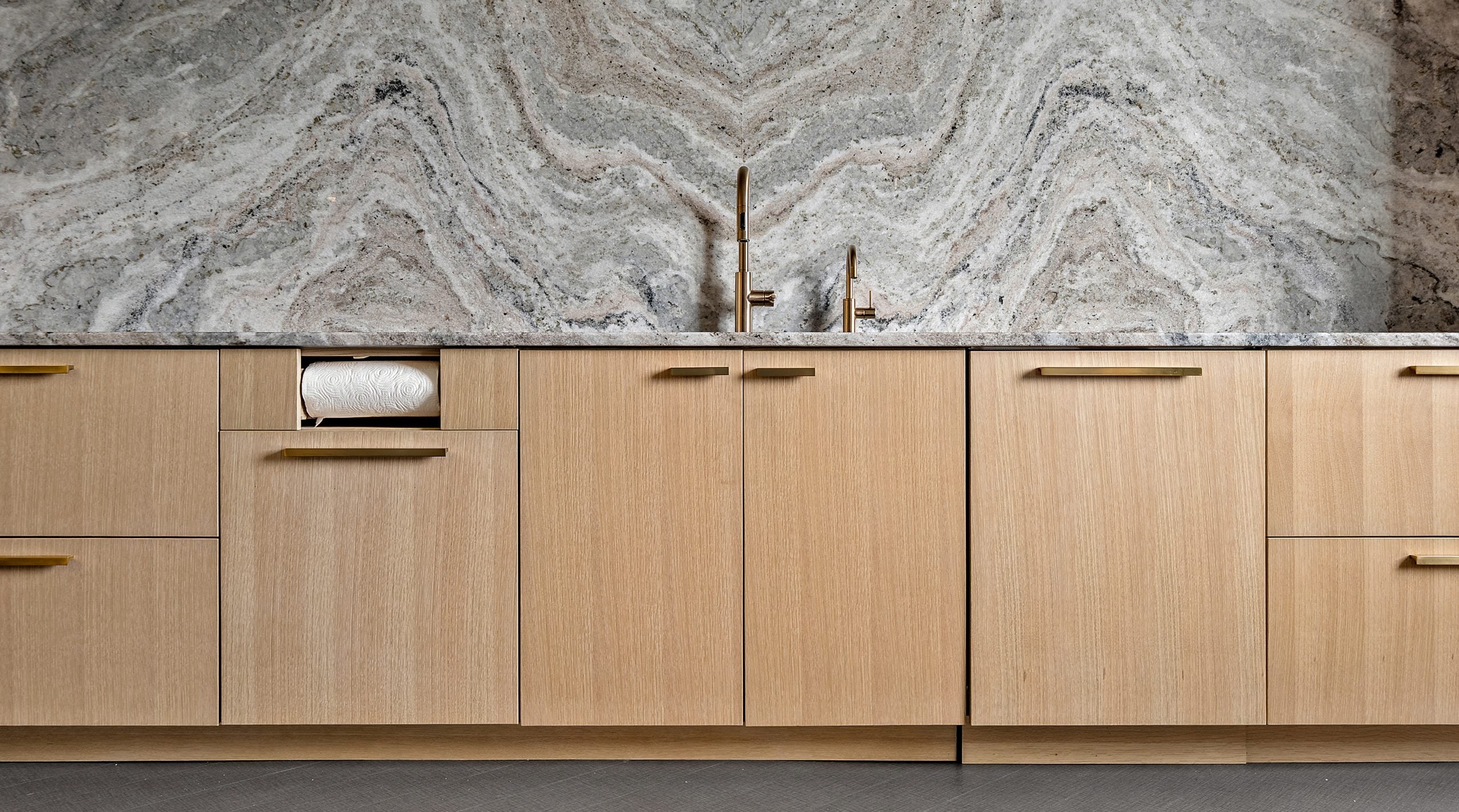 wooden cabinetry and kitchen sink with ceramic wall
